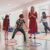 students in an inclusive PE lesson jumping in circles with a teacher watching